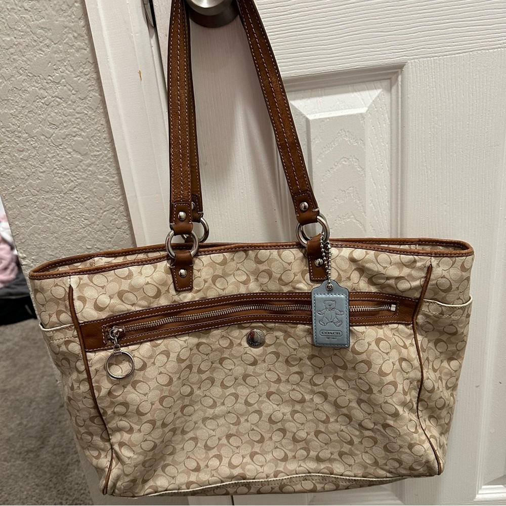 Coach canvas diaper bag with blue tag.